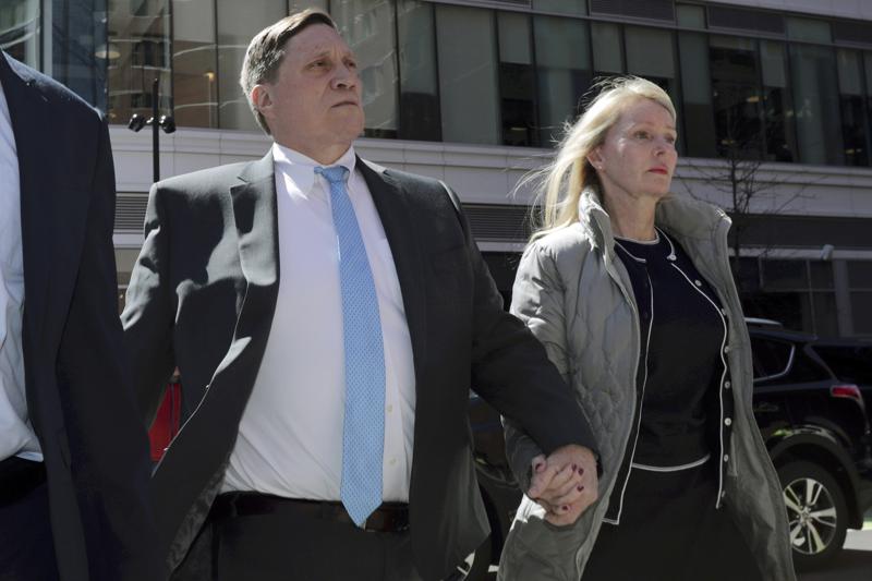 Parents convicted in college scam remain free during appeal