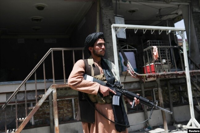 Taliban hold public execution for 2 men, who are killed by gunfire in a stadium as thousands watch